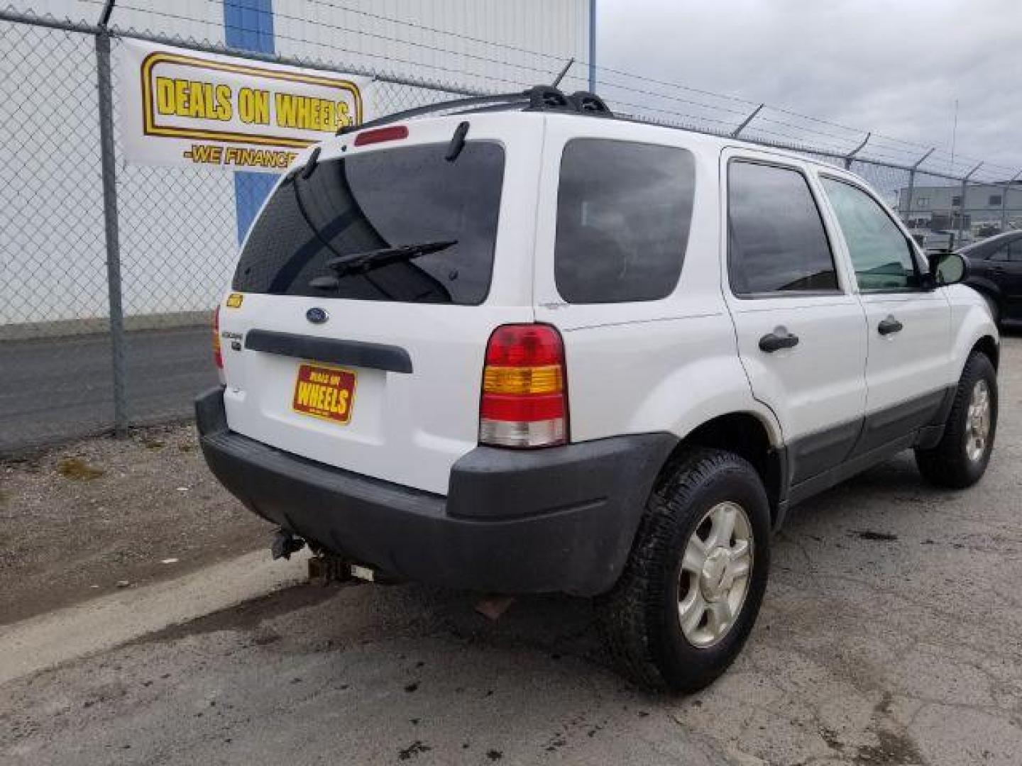 2004 Oxford White Ford Escape XLT 4WD (1FMYU93114D) with an 3.0L V6 DOHC 24V engine, 4-Speed Automatic transmission, located at 1821 N Montana Ave., Helena, MT, 59601, 46.603447, -112.022781 - Photo#4