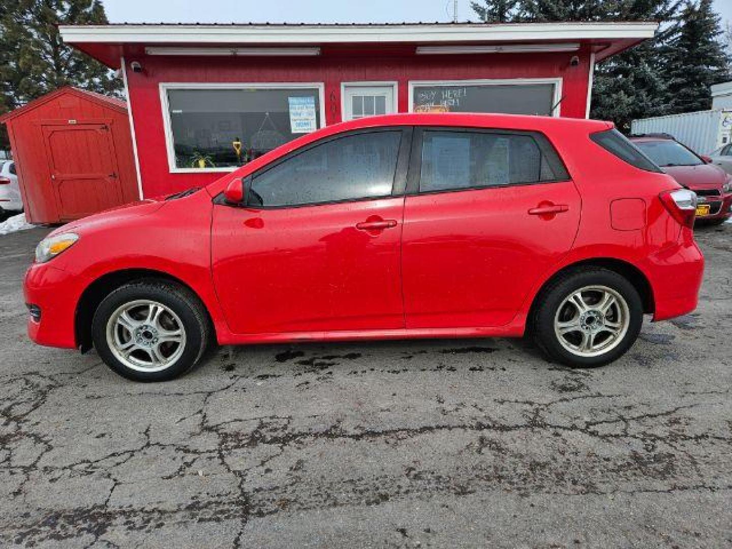 2009 Radiant Red Toyota Matrix Base 5-Speed MT (2T1KU40E09C) with an 1.8L L4 DOHC 16V engine, 5-Speed Manual transmission, located at 601 E. Idaho St., Kalispell, MT, 59901, 48.203983, -114.308662 - Photo#1